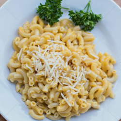 macaroni and cheese on plate with greens